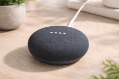 Google Nest Mini Bluetooth Speaker on a bedside table with smart home setup and soft ambient lighting